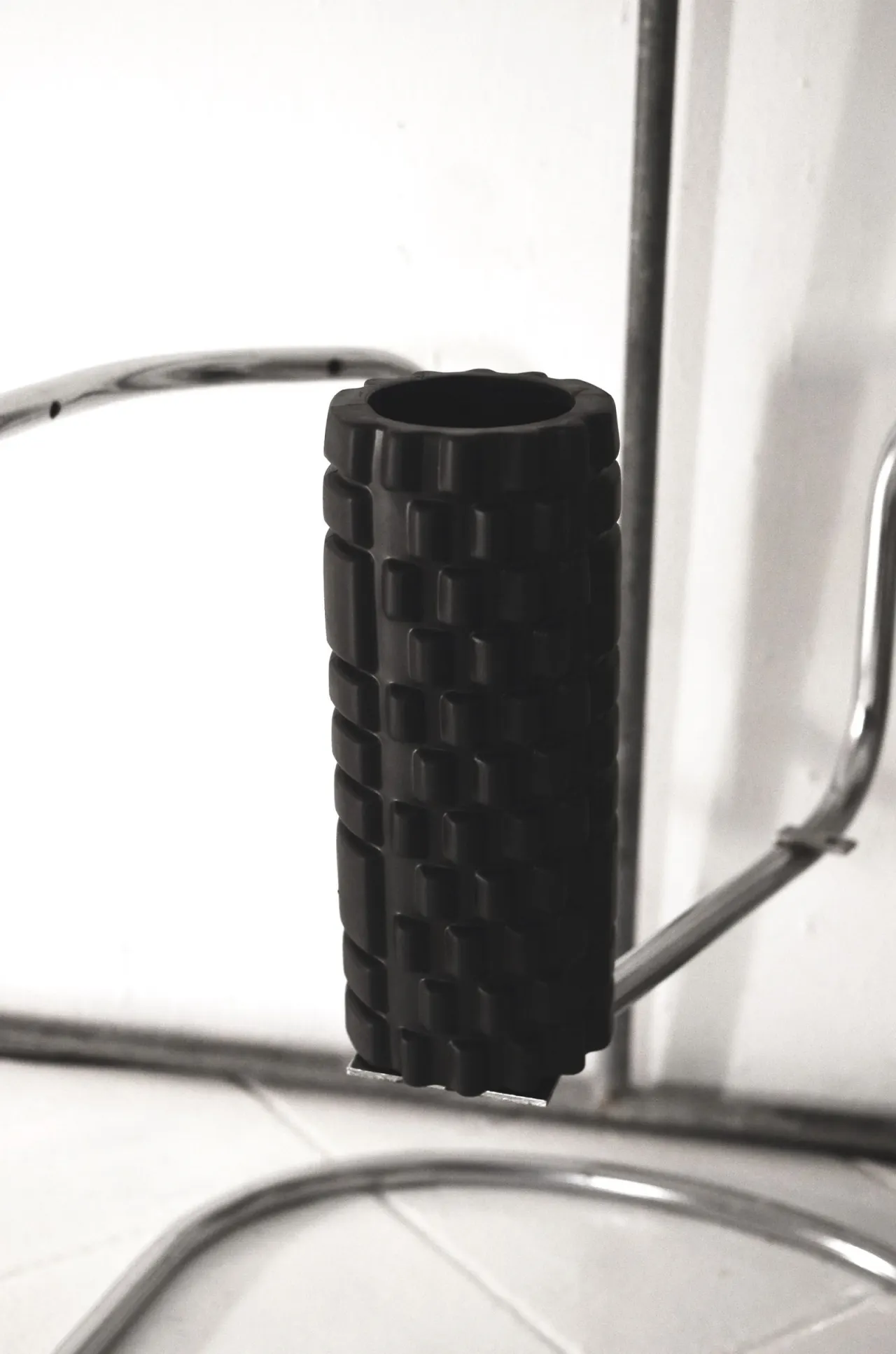 A textured foam roller set out in a quiet training space.