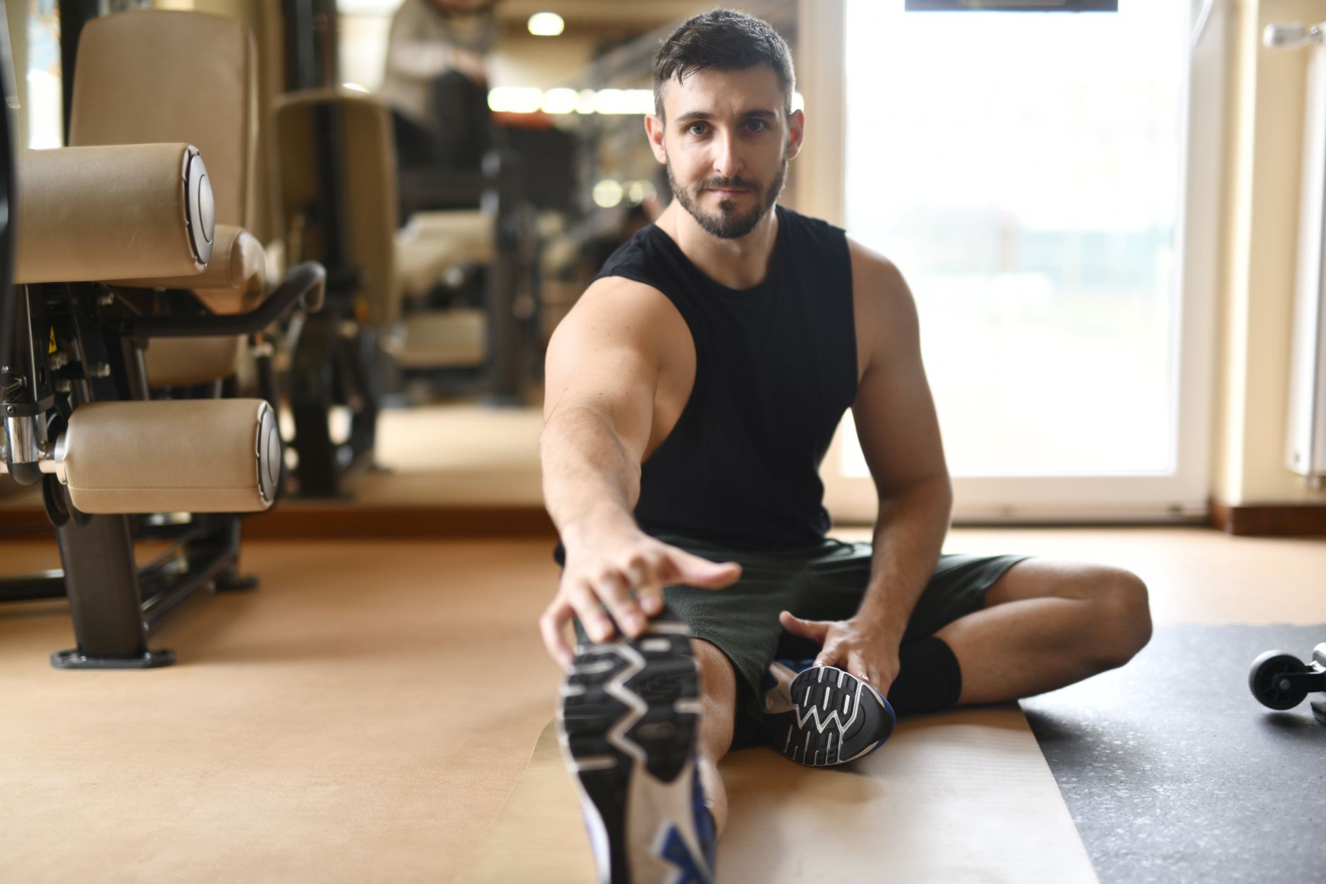 Athlete stretching during recovery work for Best recovery insights app for endurance athletes.