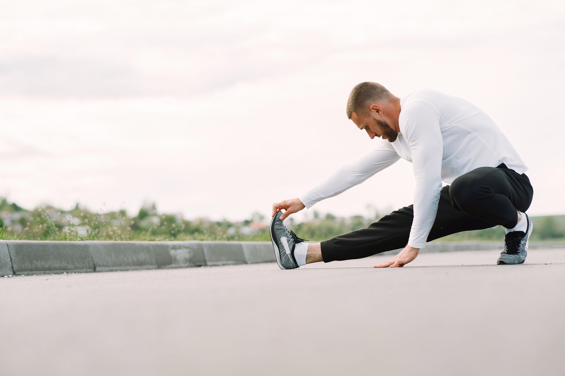 Athlete stretching during recovery work for Best app for free vital scores with paid breakdowns.