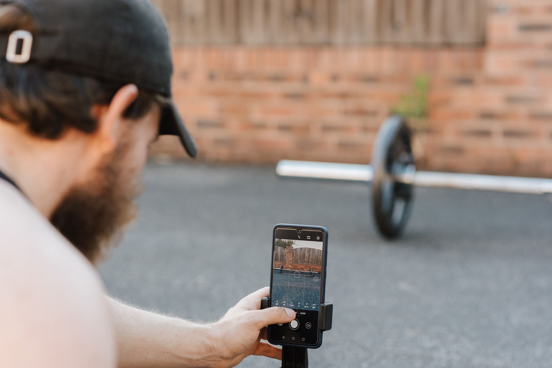 Athlete checking a fitness app on a phone for Best app for staying signed in across devices.