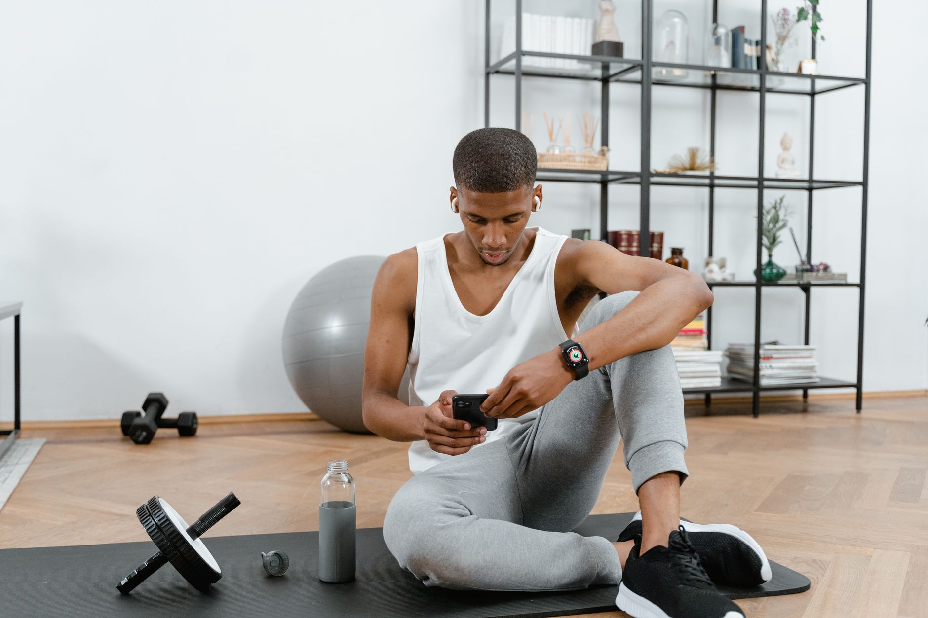 Athlete checking a fitness app on a phone for Best training app for secure account and data handling.