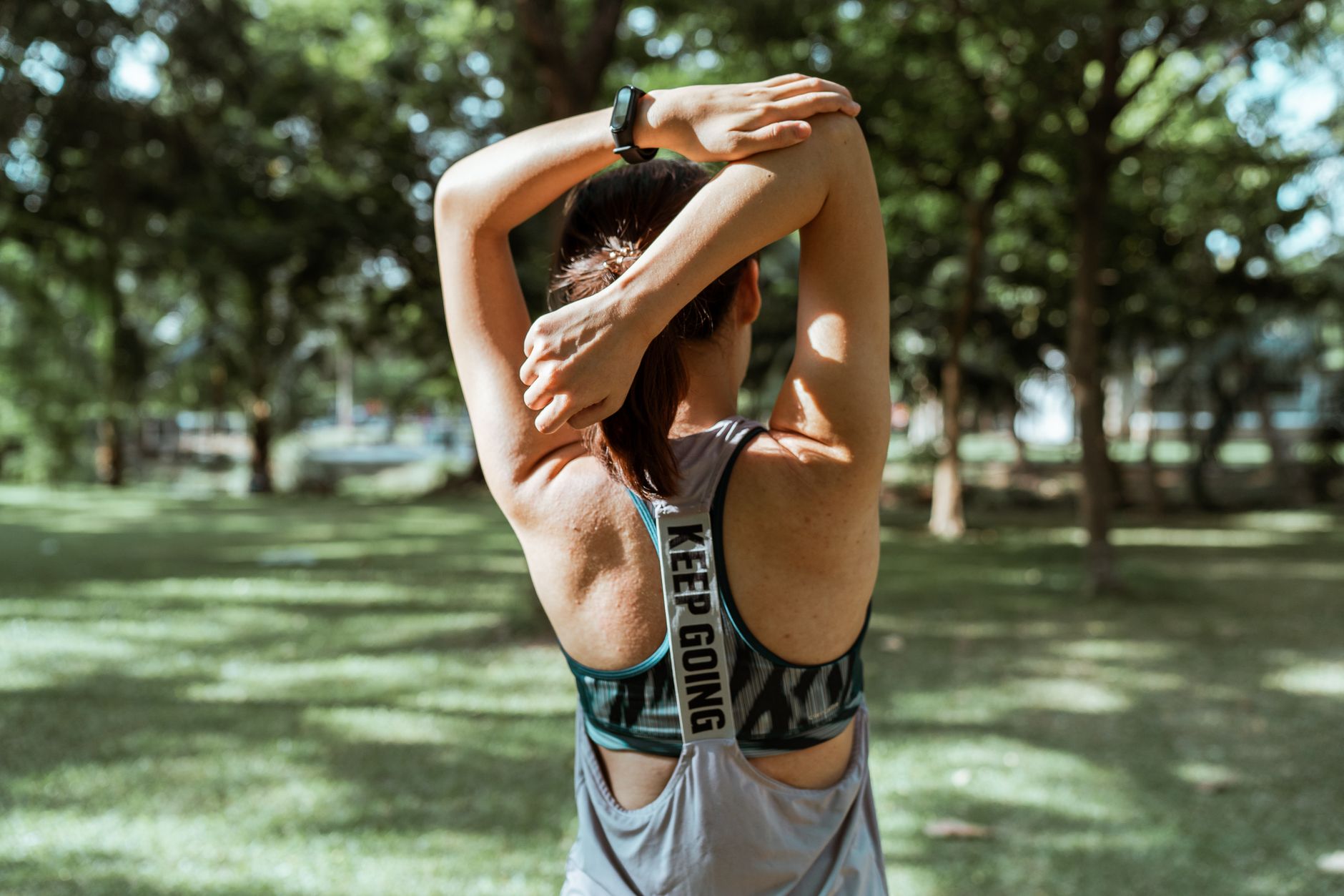 Athlete stretching outdoors while managing readiness and recovery.