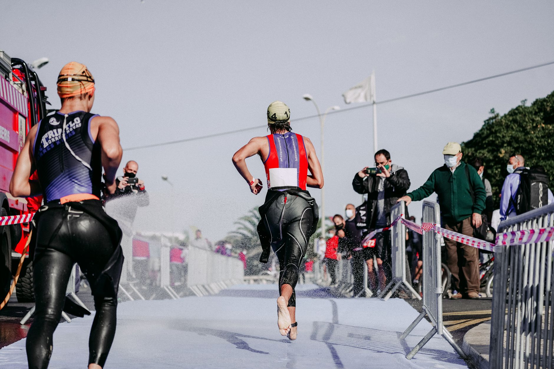 Triathletes moving through transition during adaptive race training.